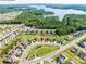 Aerial view showcases the property's location within a lakeside community surrounded by lush greenery and winding streets at 15429 Topanga Dr, Charlotte, NC 28278