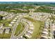 Community aerial view displaying the neighborhood layout, mature trees, and winding streets surrounded by a forest at 15429 Topanga Dr, Charlotte, NC 28278