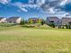 Expansive backyard showcasing manicured lawn and tasteful landscaping, perfect for outdoor activities and relaxation at 15429 Topanga Dr, Charlotte, NC 28278