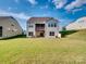 Expansive backyard with lush lawn, patio, and a covered balcony, perfect for outdoor enjoyment and entertaining at 15429 Topanga Dr, Charlotte, NC 28278