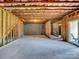 Unfinished basement area with insulation on the ceiling, concrete floor, and a sliding door to the backyard at 15429 Topanga Dr, Charlotte, NC 28278