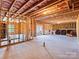 Spacious unfinished basement with exposed ceiling and sliding glass door to the yard, awaiting personalization at 15429 Topanga Dr, Charlotte, NC 28278