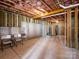 Unfinished basement featuring exposed ceiling with insulation and concrete walls ready to be customized at 15429 Topanga Dr, Charlotte, NC 28278