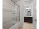 Bright bathroom with a shower-tub combo and a dark vanity at 15429 Topanga Dr, Charlotte, NC 28278