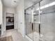 Modern bathroom featuring a glass-enclosed shower, tile surround, and a built-in bench seat at 15429 Topanga Dr, Charlotte, NC 28278