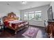Bedroom with wood floors, a patterned rug, a detailed bed frame, and lots of natural light at 15429 Topanga Dr, Charlotte, NC 28278