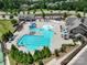 Aerial view of the neighborhood swimming pool with slides, lounge areas, and lush landscaping at 15429 Topanga Dr, Charlotte, NC 28278