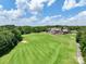 Scenic view of the lush green golf course with clubhouse and perfectly manicured fairways at 15429 Topanga Dr, Charlotte, NC 28278