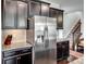 This is a kitchen with stainless steel appliances, granite countertops, and dark cabinets at 15429 Topanga Dr, Charlotte, NC 28278