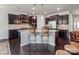 Stylish kitchen features dark cabinets, a granite island with bar seating, and stainless steel appliances at 15429 Topanga Dr, Charlotte, NC 28278