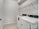 Functional laundry room featuring modern washer and dryer units, and wire shelving at 15429 Topanga Dr, Charlotte, NC 28278