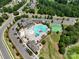Aerial view of the community pool and clubhouse, surrounded by lush landscaping and parking at 15429 Topanga Dr, Charlotte, NC 28278