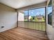 Screened porch with wood flooring featuring nice views of the backyard and the surrounding houses at 15429 Topanga Dr, Charlotte, NC 28278