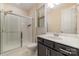 This bathroom boasts tiled shower with glass doors, tiled floors, and a large vanity with marble countertop at 15536 Oleander Dr # L228, Charlotte, NC 28278