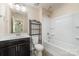 Bright bathroom featuring a vanity with storage, toilet, and shower-tub combo, all in a clean design at 15536 Oleander Dr # L228, Charlotte, NC 28278