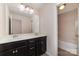 Bright bathroom features a dual sink vanity, recessed lighting and a shower/tub combination at 15536 Oleander Dr # L228, Charlotte, NC 28278