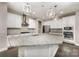 Kitchen featuring white cabinets, granite countertops, stainless steel appliances, and an island with pendant lighting at 15536 Oleander Dr # L228, Charlotte, NC 28278