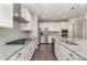 Kitchen featuring white cabinets, granite countertops, stainless steel appliances, and an island with a sink at 15536 Oleander Dr # L228, Charlotte, NC 28278