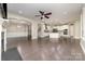 Open concept living space with hardwood floors, modern light fixtures, and seamless flow from living room to kitchen at 15536 Oleander Dr # L228, Charlotte, NC 28278