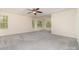 Spacious main bedroom features plush gray carpeting, recessed lighting, and natural light through windows at 15536 Oleander Dr # L228, Charlotte, NC 28278