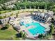 Aerial view of community pool, showing a resort-style pool with slides and ample seating at 15536 Oleander Dr # L228, Charlotte, NC 28278