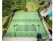 Aerial view of community tennis and pickleball courts surrounded by trees and landscaping at 15536 Oleander Dr # L228, Charlotte, NC 28278