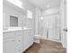 Bright bathroom featuring double vanity, framed mirror, and glass shower at 1747 Slippery Rock Ln, Monroe, NC 28112