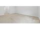 Spacious bedroom featuring neutral carpet, white walls, and ample natural light at 1747 Slippery Rock Ln, Monroe, NC 28112