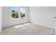 Sunlit bedroom with large windows offering charming views at 1747 Slippery Rock Ln, Monroe, NC 28112