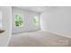 Light-filled bedroom with two large windows offering a serene outdoor view at 1747 Slippery Rock Ln, Monroe, NC 28112