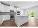 Bright kitchen features white cabinets, stainless steel appliances, a kitchen island, and a view to the outside at 1747 Slippery Rock Ln, Monroe, NC 28112