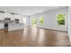Bright living room featuring hardwood floors, large windows, and modern finishes at 1747 Slippery Rock Ln, Monroe, NC 28112