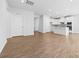 Bright living room featuring hardwood floors and modern finishes leading to the kitchen at 1747 Slippery Rock Ln, Monroe, NC 28112