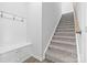 Entryway featuring a staircase, hardwood floors, and a built in bench at 1747 Slippery Rock Ln, Monroe, NC 28112