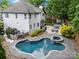 Stunning aerial view of the home's backyard featuring a beautiful pool, hot tub, and outdoor seating area at 19507 Dufour Ct, Cornelius, NC 28031