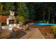 Outdoor living space with a cozy stone fireplace and comfortable seating area near the pool at 19507 Dufour Ct, Cornelius, NC 28031