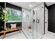 Stylish bathroom features a sleek glass shower, floating bench, and bright natural light at 19507 Dufour Ct, Cornelius, NC 28031