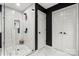 Contemporary bathroom featuring a glass shower, hexagon tile flooring, black accents, and great natural light at 19507 Dufour Ct, Cornelius, NC 28031