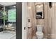 Stylish bathroom with a glass-enclosed shower, neutral tile, and modern fixtures at 19507 Dufour Ct, Cornelius, NC 28031