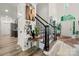 Inviting foyer with wood floors, staircase, and modern accents creates a warm welcome at 19507 Dufour Ct, Cornelius, NC 28031