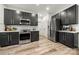 Contemporary kitchen featuring stainless steel appliances, modern countertops, and stylish cabinetry at 19507 Dufour Ct, Cornelius, NC 28031