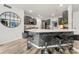 Modern kitchen features a spacious island with bar seating, gray cabinets, and stainless steel appliances at 19507 Dufour Ct, Cornelius, NC 28031