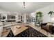 Open living area with a large sectional, hardwood floors, and views of the staircase at 19507 Dufour Ct, Cornelius, NC 28031