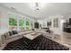 Spacious living room with large windows, comfortable sectional, and stylish decor at 19507 Dufour Ct, Cornelius, NC 28031