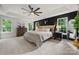 Spacious primary bedroom with large windows, stylish decor, plush carpeting, and tray ceiling at 19507 Dufour Ct, Cornelius, NC 28031