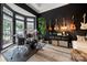 Stylish music room with black walls, hardwood floors, and natural light, perfect for entertaining and relaxation at 19507 Dufour Ct, Cornelius, NC 28031