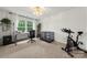 Office with large windows, modern decor, a desk, and an exercise bike at 19507 Dufour Ct, Cornelius, NC 28031