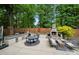 Outdoor kitchen with built-in appliances, dining table, seating area and outdoor fireplace, ideal for outdoor gatherings at 19507 Dufour Ct, Cornelius, NC 28031
