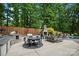 The outdoor kitchen and patio area, featuring a pizza oven, dining area, fireplace, and seating at 19507 Dufour Ct, Cornelius, NC 28031