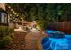 A backyard oasis featuring a pool, spa, and outdoor entertainment area with string lights at 19507 Dufour Ct, Cornelius, NC 28031